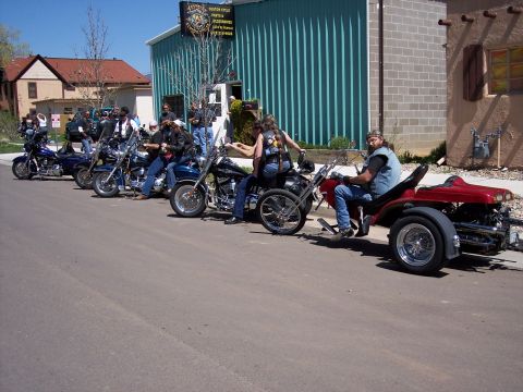 1972 Ford Ranchero - A group of motorcycles and a trike are lined up on the street.