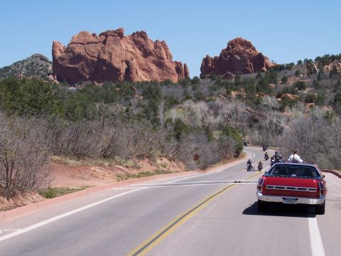 1972 Ford Ranchero - A red 1972 Ford Ranchero leads a group of motorcycles on a scenic road.
