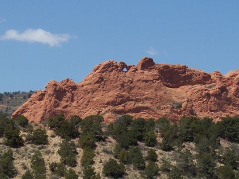 1972 Ford Ranchero - Natural rock formation with a hole in the center, set against a clear blue sky.