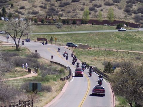 1972 Ford Ranchero - A motorcycle procession travels along a scenic, hilly road on a sunny day.