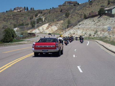 1972 Ford Ranchero - A red 1970 Ford Ranchero leads a procession of motorcycles on a winding road.