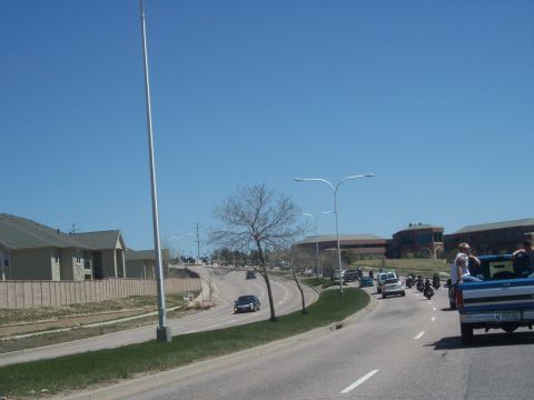 1972 Ford Ranchero - A group of motorcycles and a pickup truck are seen on a road during a rally.