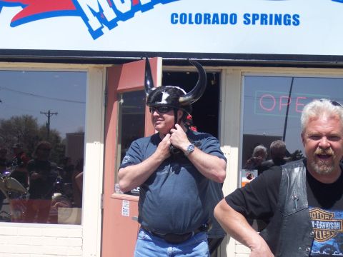 1972 Ford Ranchero - A man sporting a unique horned helmet stands outside a store with 'Colorado Springs' visible on the signage above.
