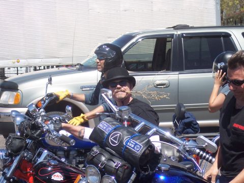 1972 Ford Ranchero - Men on motorcycles with a silver SUV in the background during an event.