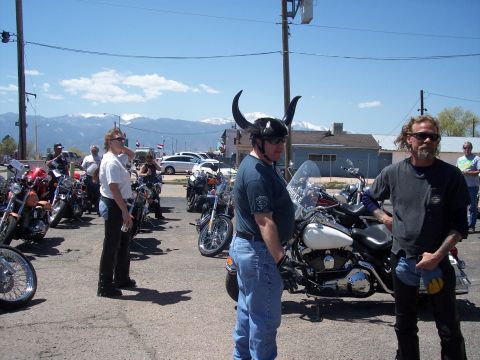 1972 Ford Ranchero - A group of people and their motorcycles are gathered outdoors on a sunny day with mountains in the background.