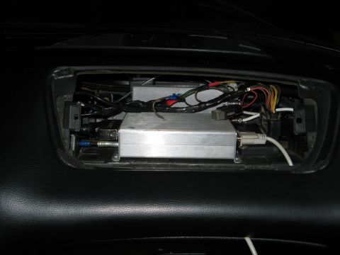 1995 Ford Probe - An aftermarket electronic device with visible wiring is installed in the dashboard cavity.