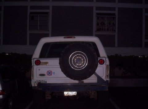 1995 Ford Bronco - This Ford Bronco has a spare tire mounted on the rear, along with some decals and a blue bumper.