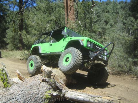 1987 Suzuki Samurai - This modified 1987 Suzuki Samurai navigates a challenging off-road obstacle.