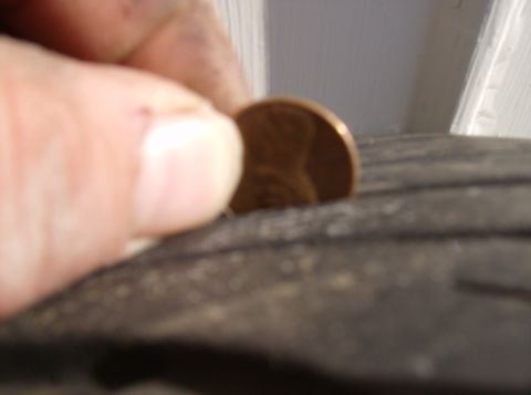 1996 Ford Probe - A penny is placed on a tire to show tread depth.