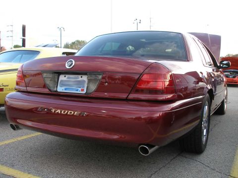 1998 Ford Crown Victoria - A maroon Mercury Marauder is parked in a lot, with another car visible in the background.
