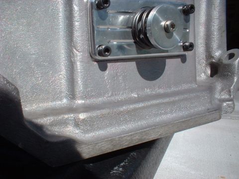 1964 Ford 427 - Close-up of an engine component, showing metallic texture and mechanical details.