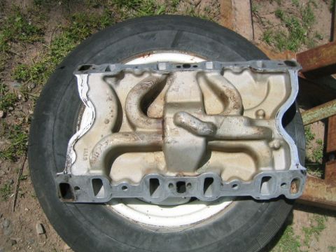 1973 Ford F-100 - An Edelbrock SP2P intake manifold is shown resting on a spare tire outdoors.