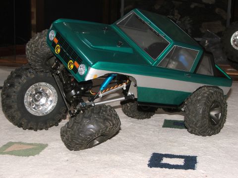 1996 Ford Bronco - This RC car features KC lights and aggressive off-road tires, resembling a classic SUV body style.