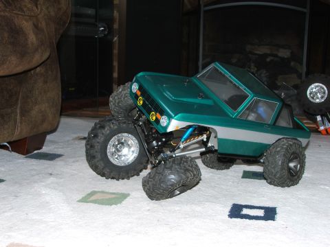 1996 Ford Bronco - RC rock crawler truck with oversized tires sits on a patterned carpet.