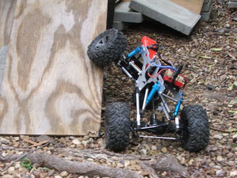 1996 Ford Bronco - A remote control rock crawler navigates an obstacle course, its tires gripping a wooden surface.
