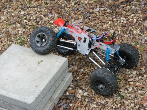 1996 Ford Bronco - RC rock crawler chassis on gravel, showing suspension and drivetrain components.