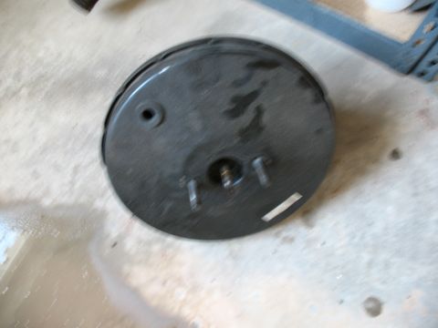 1989 Ford Bronco - Brake booster part shown in a workshop setting.