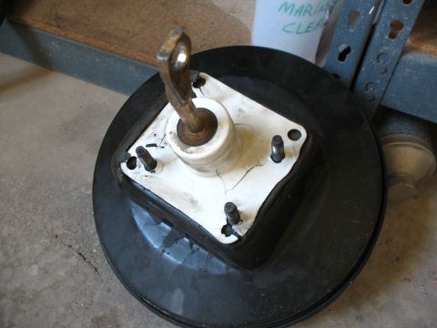 1989 Ford Bronco - A cracked brake booster part is shown in a workshop setting.