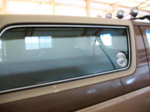 1989 Ford Bronco - Close-up of the side window on a 1989 Ford Bronco, showing a sticker on the glass.