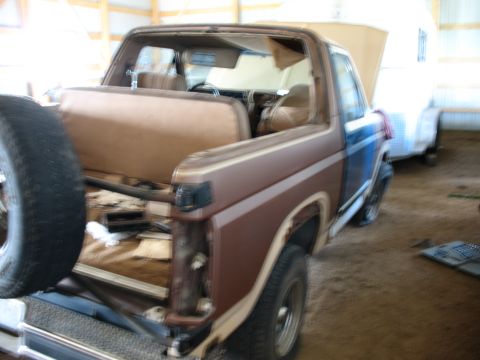 1989 Ford Bronco - This Ford Bronco appears to be undergoing some work, with its interior exposed and a second vehicle in the background.