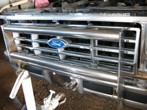1989 Ford Bronco - Close-up of the front grille and bumper of a Ford Bronco, showing the Ford emblem.