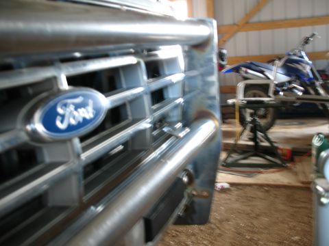 1989 Ford Bronco - Front grille detail of a 1989 Ford Bronco, showing the iconic Ford emblem.