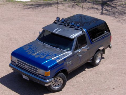 1987 Ford Bronco - This Ford Bronco has a custom paint job with flames and extra lights on the roof.