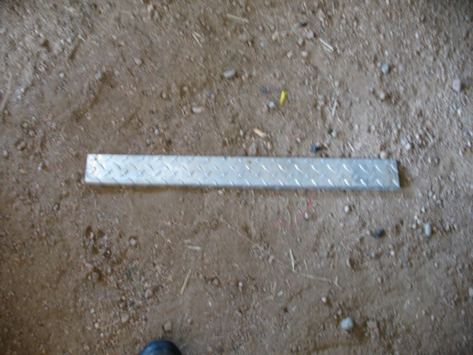 metal tread plate on dirt ground