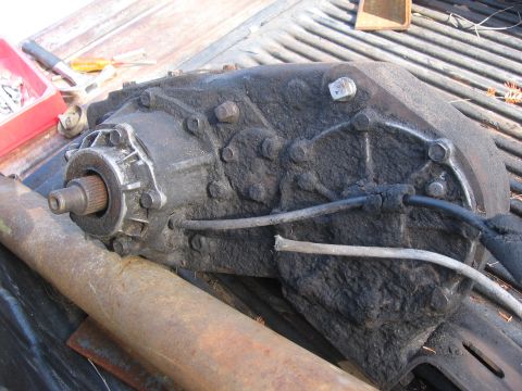 1974 Ford F-100 - A heavily greased transfer case sits on a truck bed, possibly for sale or repair.