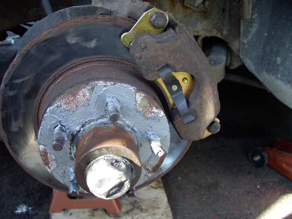 Forgot to take removal of the pads/caliper pics, so...note the 5/8" slider bolts that come out to allow caliper and pad removal.