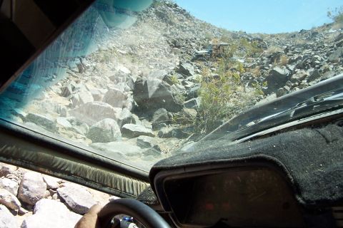 1990 Ford Bronco - Driving through a rocky, off-road landscape from the perspective of the vehicle's interior.