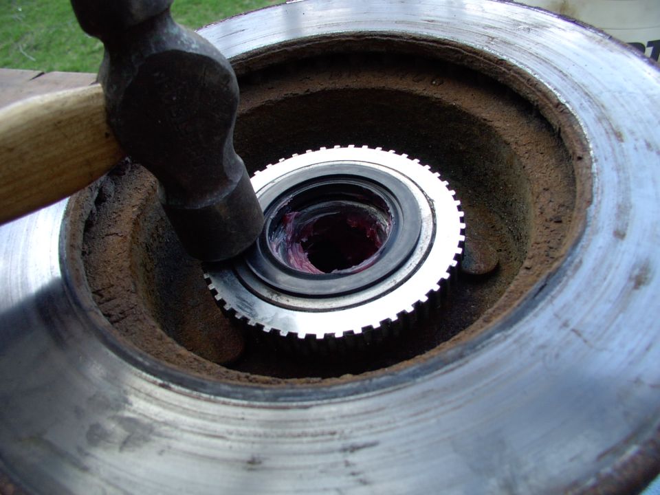 If you can't get the new inner seal to seat like this, place a large rubber mallet over it and pound the mallet with a hammer. That will spread the blows evenly and seat it easily, I find.