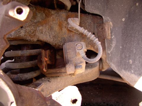 1990 Lincoln Town Car - I like the way these Lincoln calipers just tuck in on top of the lower A arm so nicely. I use a welding C-lamp vice grip to depress the pis…