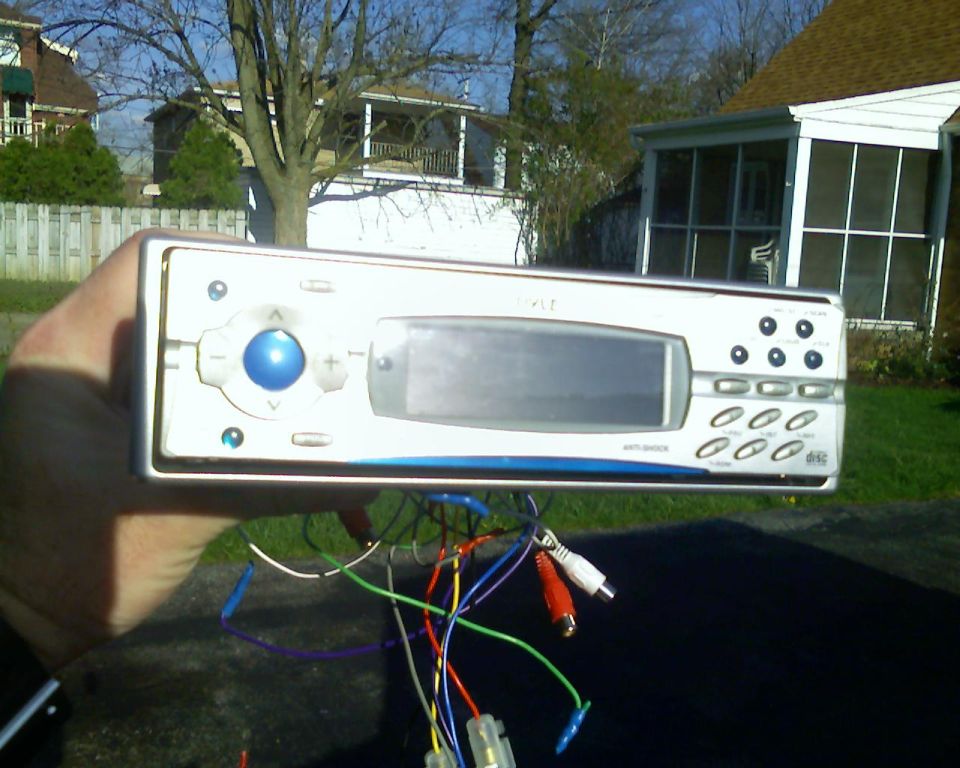Car stereo with blue button and display, wires attached