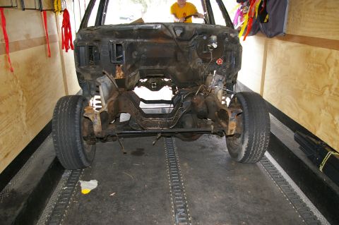 1986 Ford Bronco - Disassembled vehicle front clip being transported, with a person in the driver's seat.
