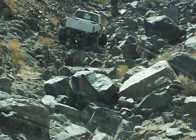 White 1990 Ford Bronco navigating rocky terrain