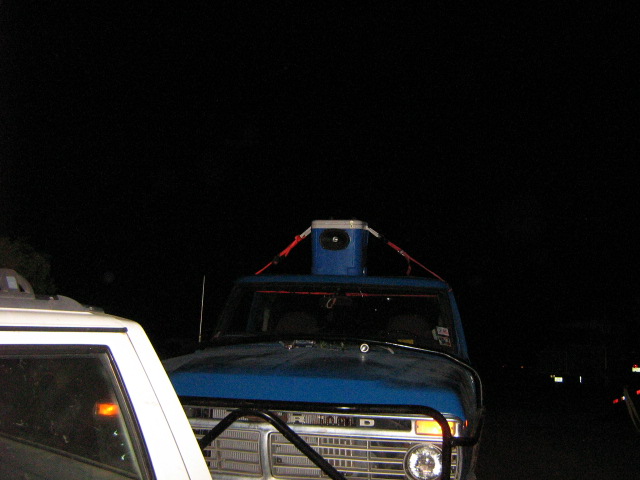 Front view of blue 1970s Ford truck with cooler on roof
