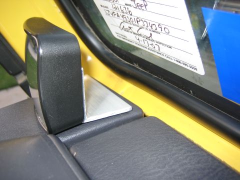 2001 Jeep Wrangler - Close-up of a vehicle's interior door handle and a window sticker containing the VIN and inspection date.