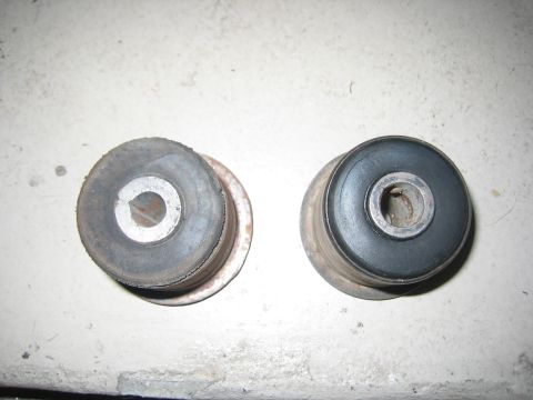 2001 Jeep Wrangler - A close-up view of two suspension bushings, one showing signs of wear and tear.
