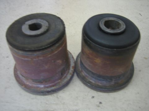 2001 Jeep Wrangler - Pair of used suspension bushings, showing wear and rust on the metal components.