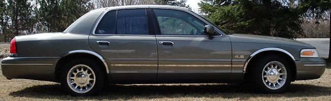 Gray four-door sedan with 4.6 badge in profile
