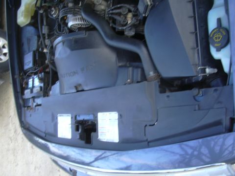 1996 Ford Crown Victoria - Close-up view of the engine compartment, showing the air intake system and battery.