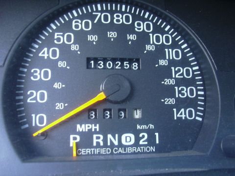 1996 Ford Crown Victoria - Close-up of a car's dashboard gauge cluster, showing speed and mileage.