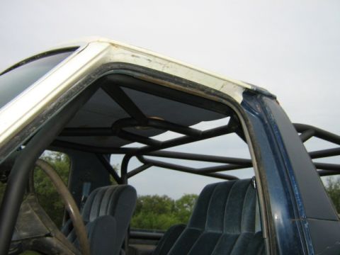 1986 Ford Bronco - 1986 Ford Bronco interior showing the custom roll cage and seats.