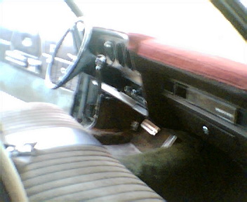 1973 Ford Ranchero - Interior view shows striped seats, dashboard, and steering wheel.