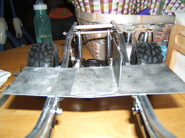 RC vehicle chassis with metal plate and tires