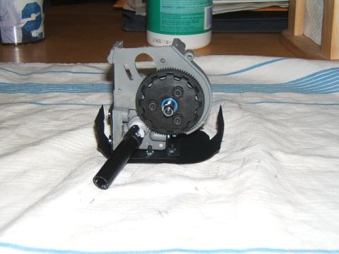 1988 Ford Bronco - Close-up view of an RC car gearbox assembly, a prominent black gear and metallic components.