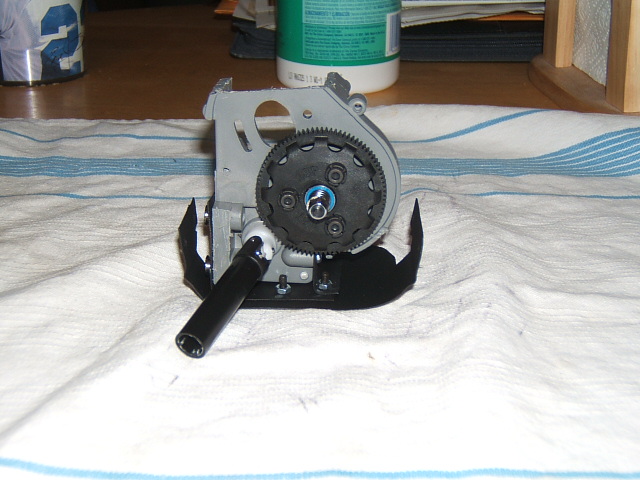 RC car gearbox with large black gear and metal housing