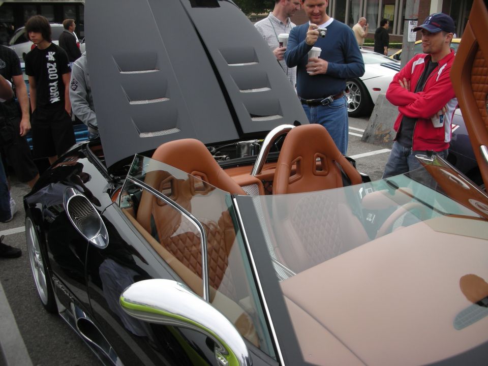 Tan quilted-leather interior of black convertible supercar at car show