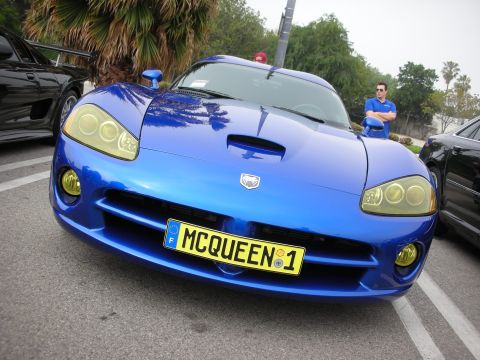 1998 Ford Crown Victoria - Front view of a blue Dodge Viper with yellow fog lamps and a yellow MCQUEEN 1 plate at a car gathering.